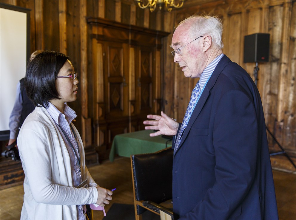 Sir Martin J. Evans in discussion with a young scientist at the 64th Meeting.