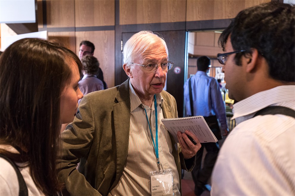 Jean-Marie Lehn conversing with young scientists.