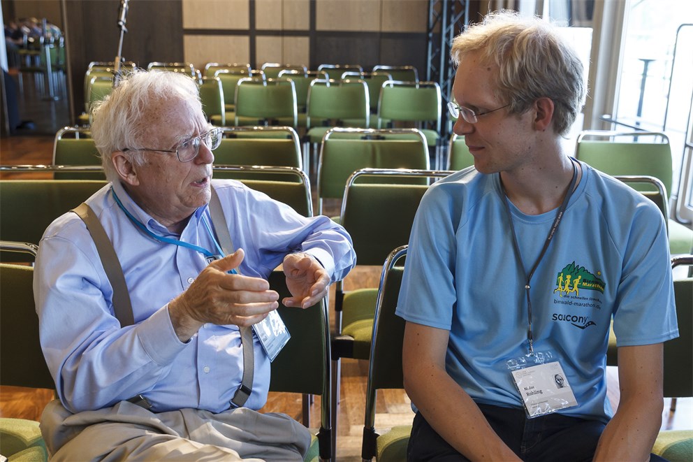 John Hall conversing with a young scientist at the 65th Lindau Nobel Laureate Meeting.