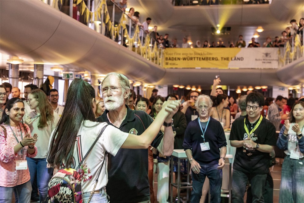 Peter Agre dancing with a Young Scientist at the Boat Trip to Lindau